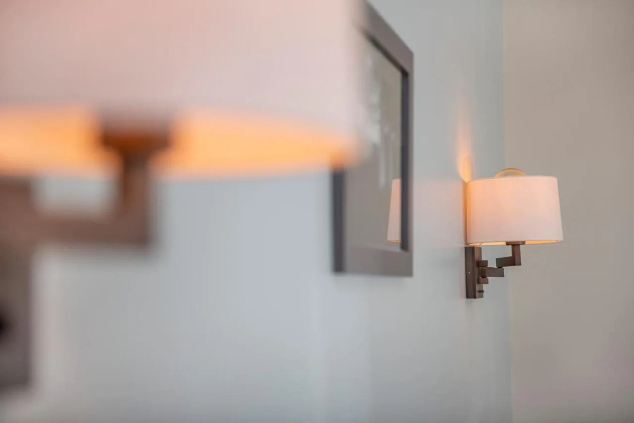 A lamp beside a cross, reflecting the building's convent heritage