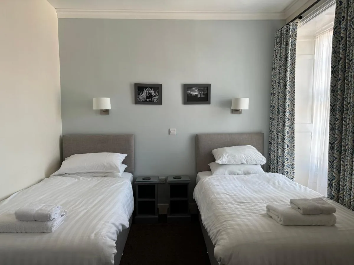 Two beds set beside one another in a York guest house room